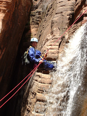 Lisa rappelling through Water Canyon