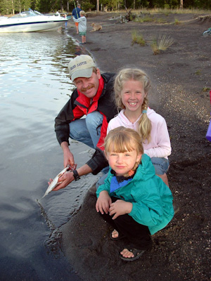 Hannan and Gina helping dad clean their first fish.