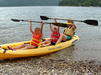 Dad taking Hannah and her cousin Emma for a Kayak ride on Swan lake.