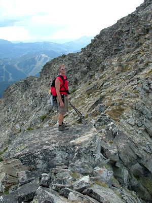 Jim Potts near the summit of Wilson Peak with the Big Sky Resort ski runs far below.